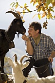 Man with two goats on Alpine pasture (Maggia Valley, Switzerland)