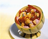 Fruit salad with yoghurt in a Charentais melon