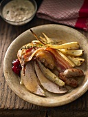 Roast pheasant with bacon, sausages and bread sauce (UK)