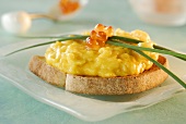 Scrambled egg, salmon caviar and chives on toast