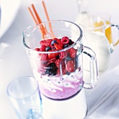 Berries and milk in liquidizer