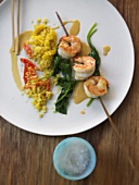 Skewered prawns with chorizo sauce, spinach and couscous