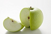A 'Granny Smith' apple with a quarter cut out