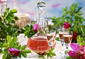 Rose liqueur in decanter and glasses