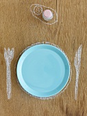 Plate, knife & fork drawn in chalk, salt shaker in background
