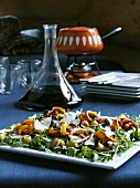 Grilled vegetables with Parmesan on a bed of rocket