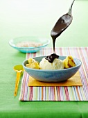 Pineapple ice cream, pieces of grilled pineapple, chocolate sauce