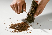 Making chocolate shavings with a knife