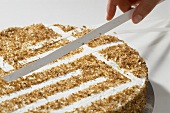 Removing strips of paper from a tea punch cake