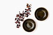 Dried tea leaves and two tea bowls