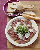 Lukewarm beef carpaccio with beans and mushrooms