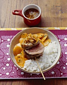 Skewered pork fillet with carrots and rice