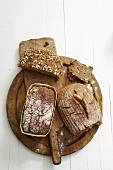 Various types of bread on wooden breadboard