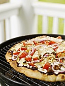 Greek pizza on a barbecue