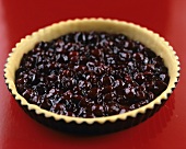 Shortcrust pastry case filled with cherries (unbaked)