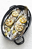 Trout with almonds, grapes and lemon in aluminium foil