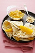 Pancakes with peach slices and flaked almonds