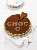 Chocolate tart with the word Choco, a piece cut