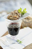 Goose rillettes on a slice of bread, glass of red wine