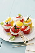 Red and yellow cherry tomatoes filled with soft cheese