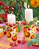 Candles in mugs filled with crab-apples