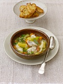 Fish and vegetable soup served with toast