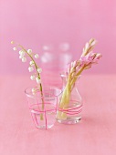 Lily of the valley in a glass and hyacinths in a vase