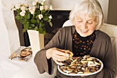 Elderly lady eating biscuits