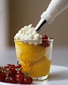 Ice cream dessert with redcurrants and cream