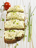 Slices of bread with cheese and potato spread and chives