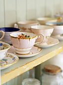 Old china cups and saucers on a shelf