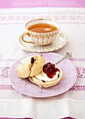 Scone with cream and jam and a cup of orange tea
