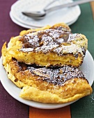 Soufflé omelette with orange sauce and icing sugar