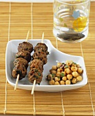 Meatballs on skewers and chick-peas