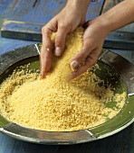 Fluffing couscous (tradition food preparation)