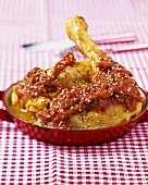 Chicken with tomato sauce and sesame seeds