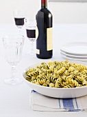 Fusilli with mint pesto, red wine in background