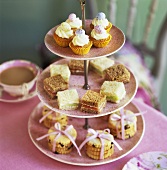 Cupcakes, dainty sandwiches and biscuits on tiered stand