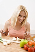 Young woman slicing vegetables