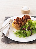 Baked potatoes with chili con carne and salad