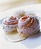 Salmon rolls on white sauce