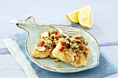 Fish fillet with garlic and pine nuts