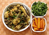 Chicken drumsticks with mushrooms, carrots and parsley