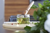 Herb marinade in jar with brush