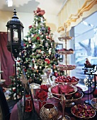 Christmas decorations on tiered stand, Christmas tree in background