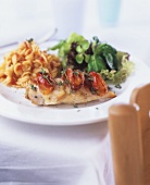 Fried chicken breast with pasta and salad