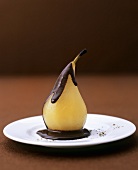 Poached pear with chocolate sauce and pepper