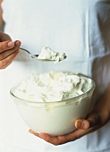 Taking a spoonful of crème Chantilly (French sweetened whipped cream)