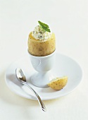 Boiled potato with cottage cheese and herbs in eggcup