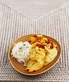 Fish in batter with peppers, almonds and rice